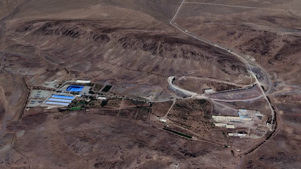 Satellite imagery shows the Shahid Soltani Garrison, outside of Eshtehard City, Iran, including large storage warehouses (left), a set of smaller buildings (right) and an underground tunnel with two openings (center). (NCRI/MEK)